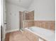 Bathroom featuring a bathtub, a tiled shower with glass door, and tiled floor at 10686 Austen Bnd, Alpharetta, GA 30022