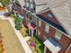 A group of well-maintained townhomes show brick and siding, complemented by vibrant landscaping and sidewalks at 10686 Austen Bnd, Alpharetta, GA 30022