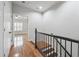Upstairs hallway with wood floors and railing, leading to a light-filled room at 10686 Austen Bnd, Alpharetta, GA 30022