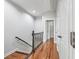Staircase with hardwood floors and metal spindles, leads to the next level at 10686 Austen Bnd, Alpharetta, GA 30022