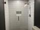 Updated bathroom features a tiled shower with a glass door and built-in niche at 5415 Windcrest Ln, Suwanee, GA 30024