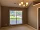 Dining room featuring a large window and neutral walls, offering a serene space for Gathering meals at 5415 Windcrest Ln, Suwanee, GA 30024