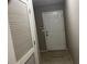 Hallway with a closet and view to a white front door entrance at 5415 Windcrest Ln, Suwanee, GA 30024