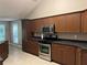 Functional kitchen with stainless steel appliances and wooden cabinets, ideal for preparing delicious meals at 5415 Windcrest Ln, Suwanee, GA 30024