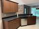 Kitchen featuring granite countertops, stainless steel appliances, and wooden cabinets at 5415 Windcrest Ln, Suwanee, GA 30024