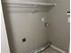 A simple laundry room with connections for a washer and dryer, and wire shelving at 5415 Windcrest Ln, Suwanee, GA 30024