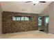 Another view of the living room featuring a rock wall and view into the kitchen at 5415 Windcrest Ln, Suwanee, GA 30024