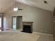 Spacious living room with fireplace and vaulted ceiling, perfect for cozy evenings and entertaining guests at 5415 Windcrest Ln, Suwanee, GA 30024