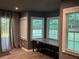 Living room boasts wood-look floors, three large windows for natural light, and a built-in desk at 5415 Windcrest Ln, Suwanee, GA 30024