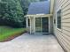 A spacious, light beige, back patio, with a sliding glass door entrance to the home at 5415 Windcrest Ln, Suwanee, GA 30024