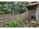 Fenced backyard with mature trees, shrubs, and a patio providing privacy and a natural setting for outdoor enjoyment at 1154 Village Se Ct, Atlanta, GA 30316