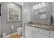Well-lit bathroom featuring a granite-topped vanity, and a window for natural light, creating a clean and functional space at 1154 Village Se Ct, Atlanta, GA 30316