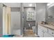 Well-lit bathroom featuring a shower-tub combo, granite-topped vanity, and a window for natural light, creating a functional space at 1154 Village Se Ct, Atlanta, GA 30316