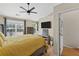 Bright bedroom featuring a large window, ceiling fan, television, and stylish decor, creating a comfortable and inviting retreat at 1154 Village Se Ct, Atlanta, GA 30316