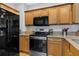 Kitchen with stainless steel appliances, wood cabinets, and granite countertops at 1154 Village Se Ct, Atlanta, GA 30316