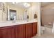 Bathroom featuring double sinks, wood cabinetry, a large mirror, and a separate shower/tub enclosure at 1527 Sage Ridge Dr, Marietta, GA 30064