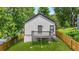 Back exterior of home with small deck and wood privacy fence at 556 Paines Nw Ave, Atlanta, GA 30318