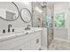 Elegant bathroom featuring a double vanity, marble countertops, and a glass-enclosed shower at 556 Paines Nw Ave, Atlanta, GA 30318