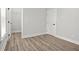 Bright bedroom with light gray walls, wood-look floors, closet, and white trim at 556 Paines Nw Ave, Atlanta, GA 30318