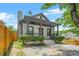 Charming home boasting a covered front porch, mature landscaping, and a well-maintained front yard at 556 Paines Nw Ave, Atlanta, GA 30318