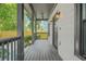 Inviting covered front porch with gray wood floors, a ceiling fan, and black railings offer outdoor relaxation at 556 Paines Nw Ave, Atlanta, GA 30318