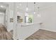 Open-concept kitchen featuring a peninsula, white cabinetry, and stylish pendant lighting at 556 Paines Nw Ave, Atlanta, GA 30318