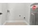 This laundry room has white walls and tile floors at 556 Paines Nw Ave, Atlanta, GA 30318