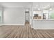 Bright living room featuring wood floors open to a modern kitchen with white cabinets and stainless steel appliances at 556 Paines Nw Ave, Atlanta, GA 30318