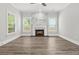 Bright living room featuring a stone fireplace, wood floors, and ample natural light at 556 Paines Nw Ave, Atlanta, GA 30318