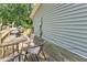 Wooden back deck featuring a dark dining set and grill, perfect for outdoor entertaining at 111 Marona Street Ne Ne St, Atlanta, GA 30307
