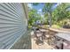 Back deck with a dining set, a grill, and lovely green views of a tree-filled backyard at 111 Marona Street Ne Ne St, Atlanta, GA 30307