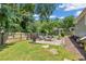 Backyard featuring a brick firepit with outdoor seating, green grass, landscaping, and a wood fence at 111 Marona Street Ne Ne St, Atlanta, GA 30307