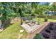 Backyard featuring a brick firepit with outdoor seating, a wood fence, and landscaping at 111 Marona Street Ne Ne St, Atlanta, GA 30307