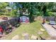 Backyard featuring a storage shed, red lawn chairs, wood fence, and green grassy area at 111 Marona Street Ne Ne St, Atlanta, GA 30307