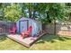 Backyard featuring a storage shed, red lawn chairs, grass, and a wood fence at 111 Marona Street Ne Ne St, Atlanta, GA 30307