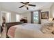 Bedroom with neutral paint, a window with blinds, a ceiling fan, and ensuite closet and bathroom at 111 Marona Street Ne Ne St, Atlanta, GA 30307