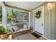 View of front porch with hanging bench, front door with wreath, and plants at 111 Marona Street Ne Ne St, Atlanta, GA 30307
