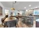 Open floorplan with kitchen island, dining area, living room, and view to the bedroom at 111 Marona Street Ne Ne St, Atlanta, GA 30307