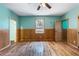Spacious bedroom with light teal walls, wood floors, and a large window at 3192 Highway 411 Ne, White, GA 30184