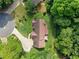 Aerial view of a home on a cul-de-sac with driveway and mature trees at 3436 Laurelwood Ne Ct, Roswell, GA 30075