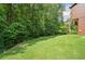 Lush backyard featuring a well-maintained lawn and mature trees for privacy at 3436 Laurelwood Ne Ct, Roswell, GA 30075