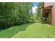 Expansive backyard showcasing lush greenery, mature trees, and partial view of the home at 3436 Laurelwood Ne Ct, Roswell, GA 30075
