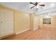Versatile basement space with hardwood flooring, a ceiling fan, natural light and an exterior door at 3436 Laurelwood Ne Ct, Roswell, GA 30075