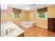 Bathroom featuring dual sinks and a corner tub for a spa-like experience at 3436 Laurelwood Ne Ct, Roswell, GA 30075