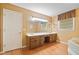 Bathroom boasting dual sinks, a large mirror, and a tub at 3436 Laurelwood Ne Ct, Roswell, GA 30075