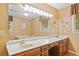 Bathroom featuring dual sinks, a large mirror, vanity and a tub at 3436 Laurelwood Ne Ct, Roswell, GA 30075