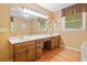 Bathroom boasting dual sinks, a large mirror, and window at 3436 Laurelwood Ne Ct, Roswell, GA 30075