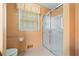 Bathroom with a glass-enclosed shower, toilet, and a window providing natural light at 3436 Laurelwood Ne Ct, Roswell, GA 30075