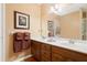 Bathroom with dual sinks, framed mirror and updated light fixture at 3436 Laurelwood Ne Ct, Roswell, GA 30075