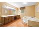 Bathroom boasting dual sinks, a large mirror, and a tub for relaxation at 3436 Laurelwood Ne Ct, Roswell, GA 30075